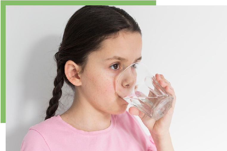 A girl drinking water from a glass